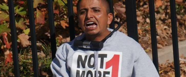 Adrian participating in a civil disobedience outside of the Atlanta ICE office as part of the #Not1More Campaign in November 2013.